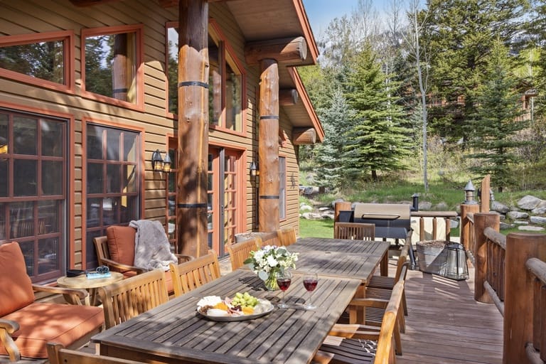 Wooden deck with outdoor dining setup.