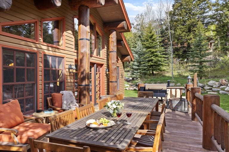 Outdoor wooden deck with dining table.