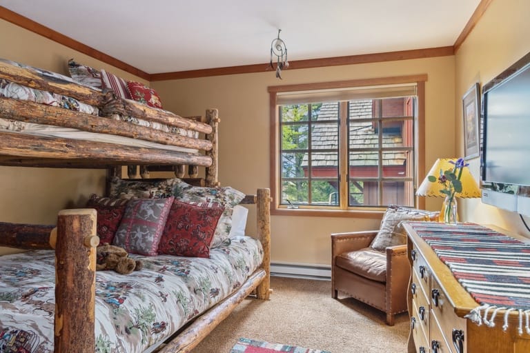 Cozy bedroom with log bunk beds.