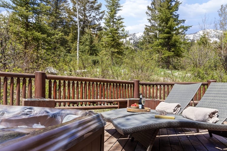 Deck with loungers and forest view.