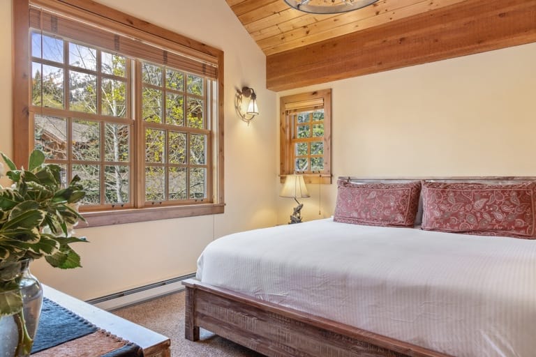 Cozy bedroom with large windows.