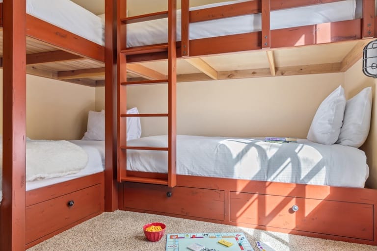Bunk beds with board game setup.