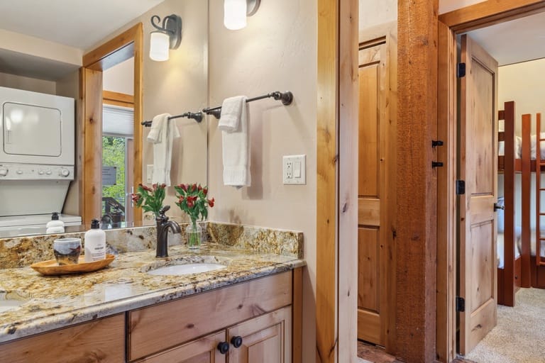 Rustic bathroom with laundry area.