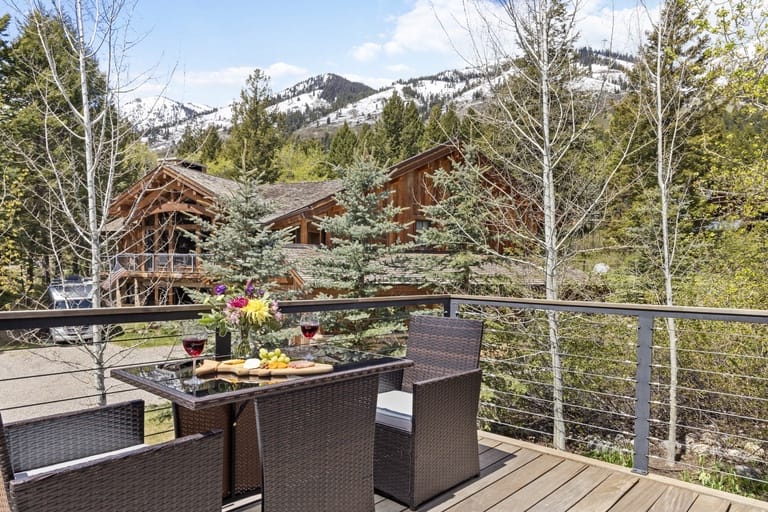 Deck view of mountains and cabin.