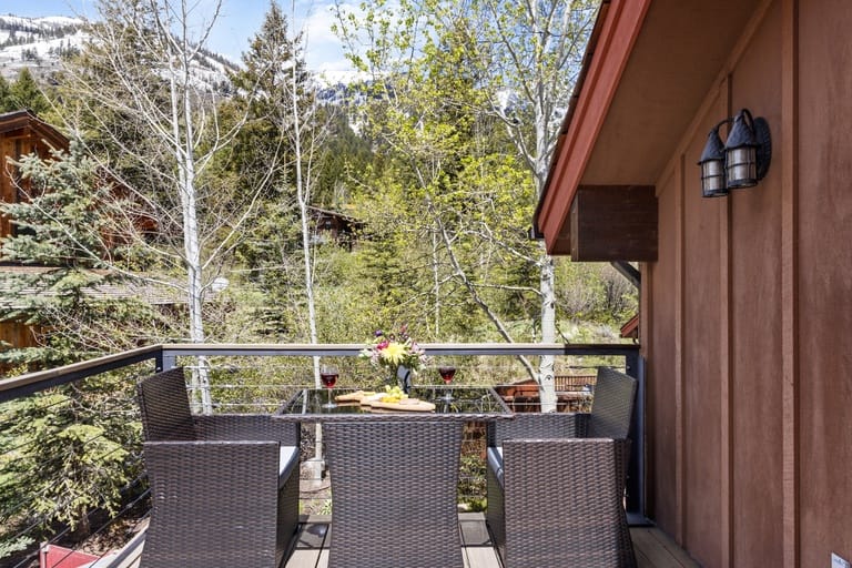 Balcony with chairs, mountain view.