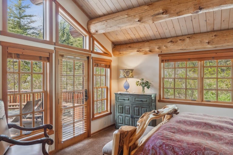 Cozy rustic-style bedroom with windows.