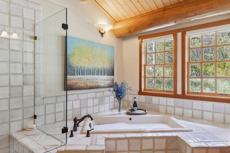 Cozy bathroom with tub and windows.