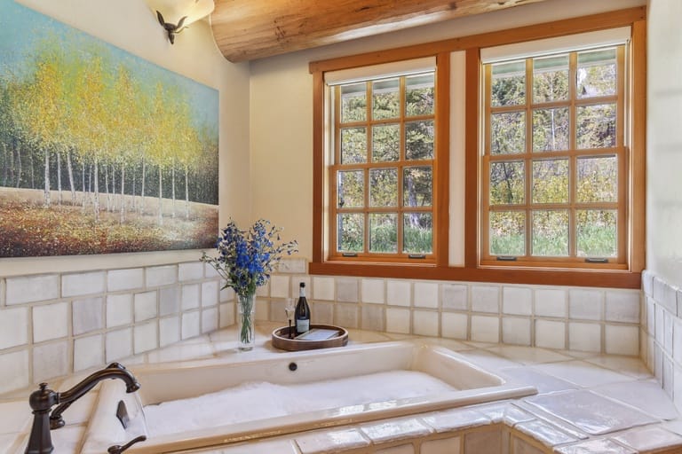 Cozy bathroom with painting, window.