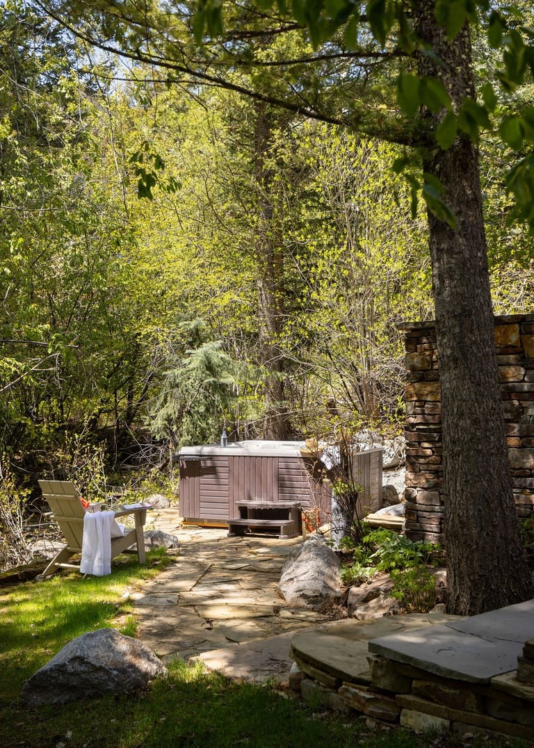 Outdoor hot tub in forest setting.