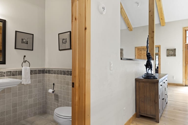 Bathroom and hallway with wooden accents.