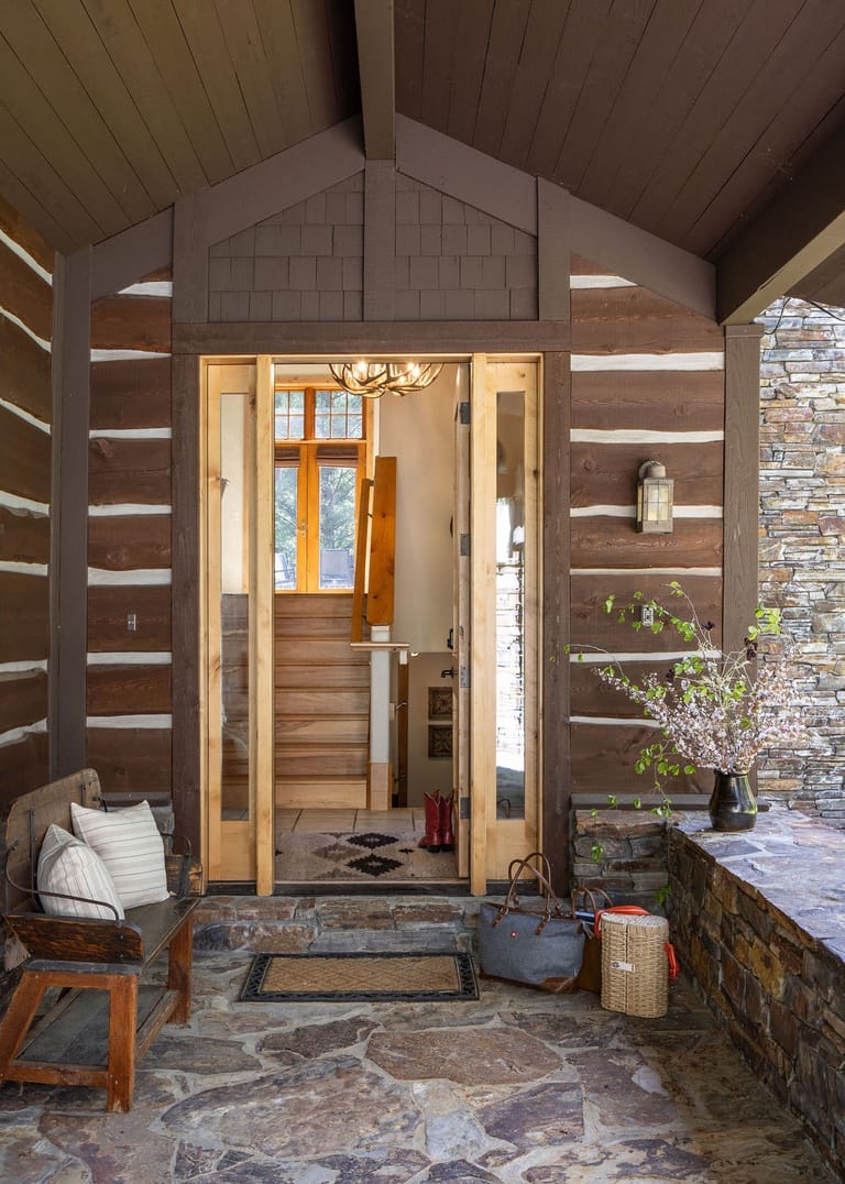 Rustic doorway with stone porch.