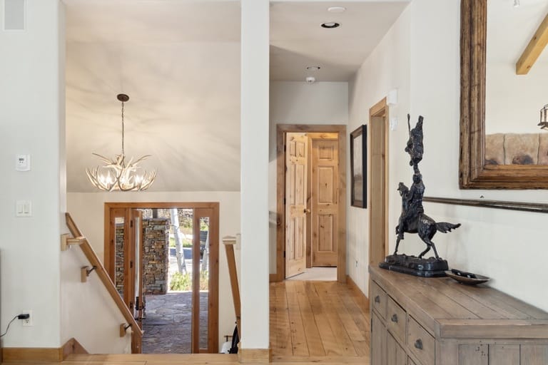Home interior with stairs and sculpture.