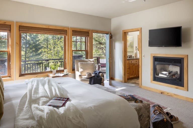 Cozy bedroom with fireplace, balcony.