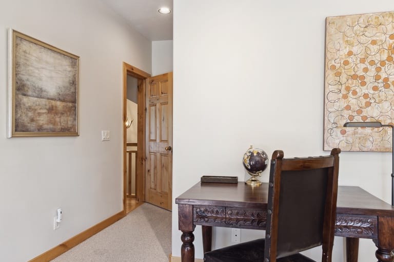 Desk and artwork in hallway.