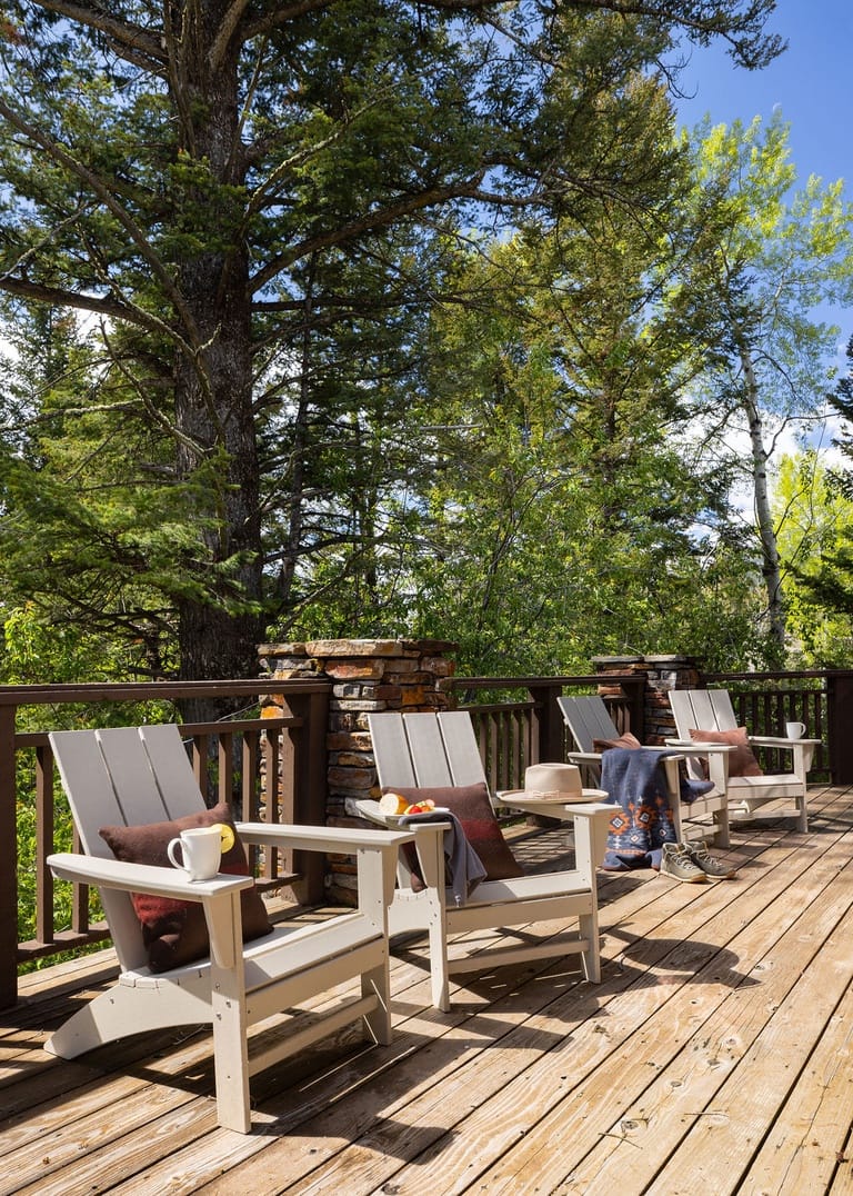 Chairs on deck, forest backdrop.