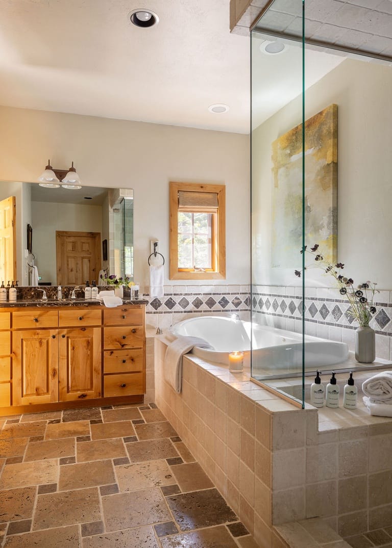 Cozy bathroom with bathtub, vanity.