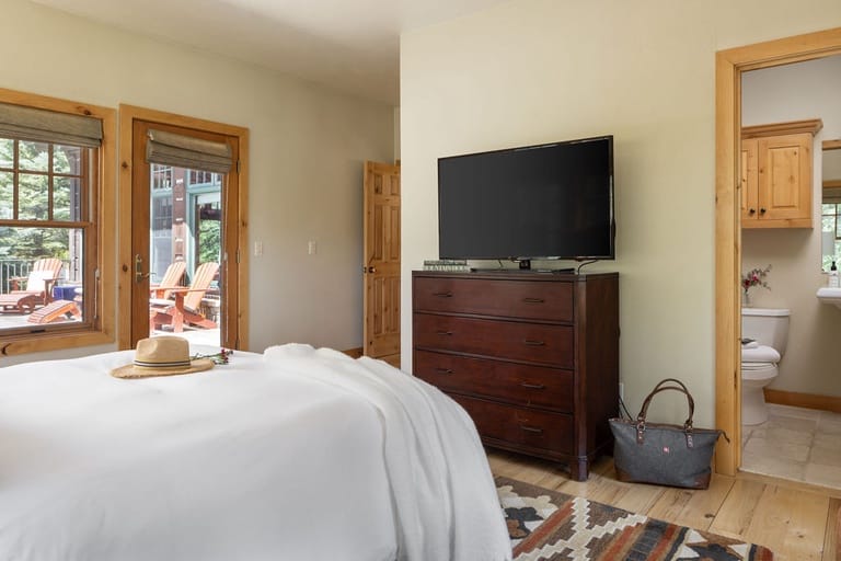 Bedroom with TV and bathroom.