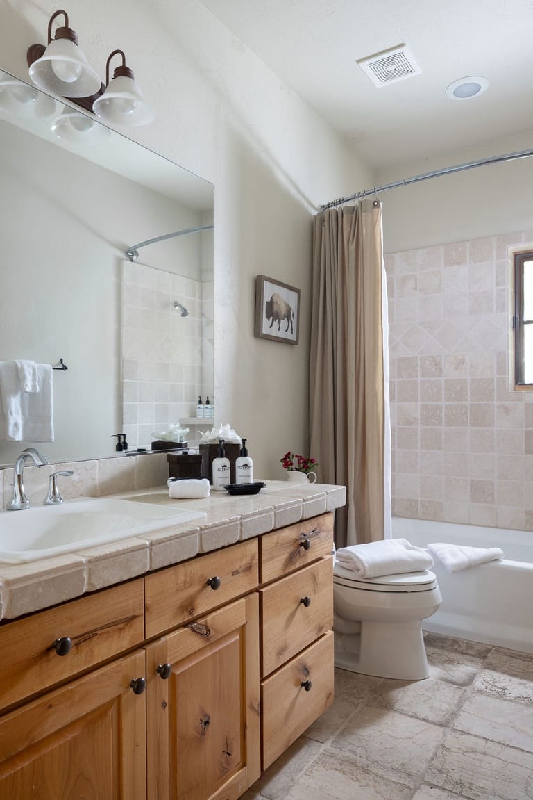 Cozy bathroom with wooden cabinets.