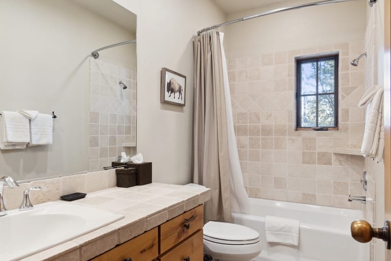 Cozy bathroom with shower curtain.
