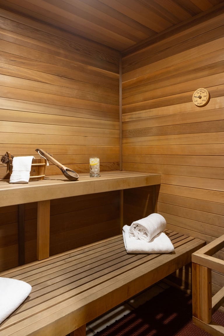 Wooden sauna interior with towels.