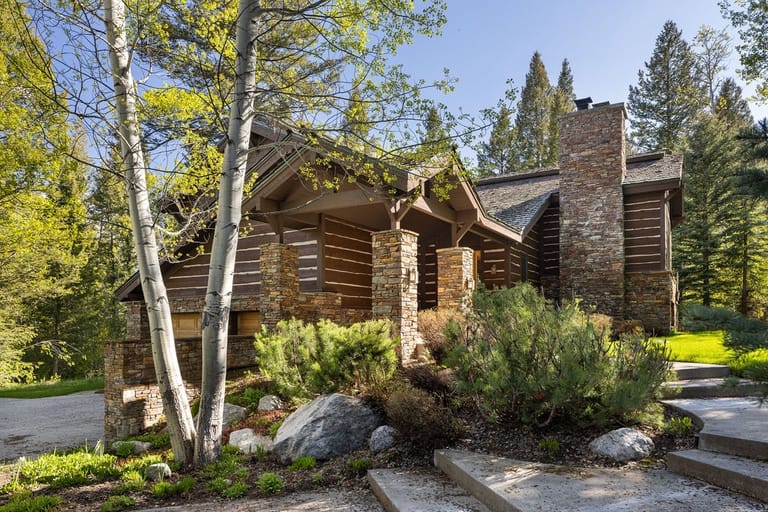 Rustic cabin surrounded by trees.