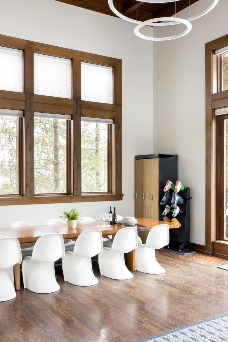 Modern dining room with white chairs.