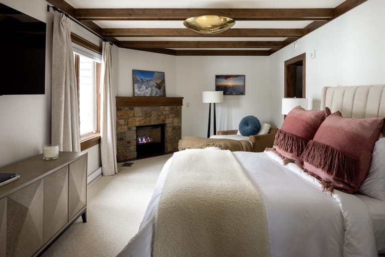 Cozy bedroom with fireplace, bed.