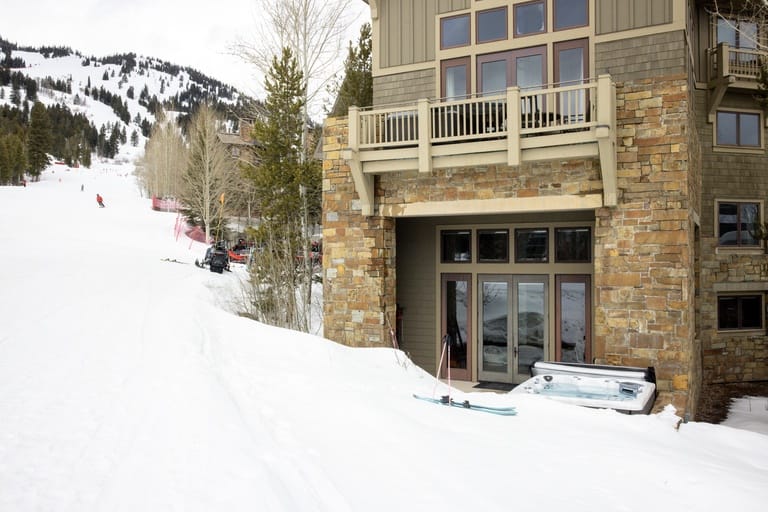 Mountain chalet with snow, hot tub.