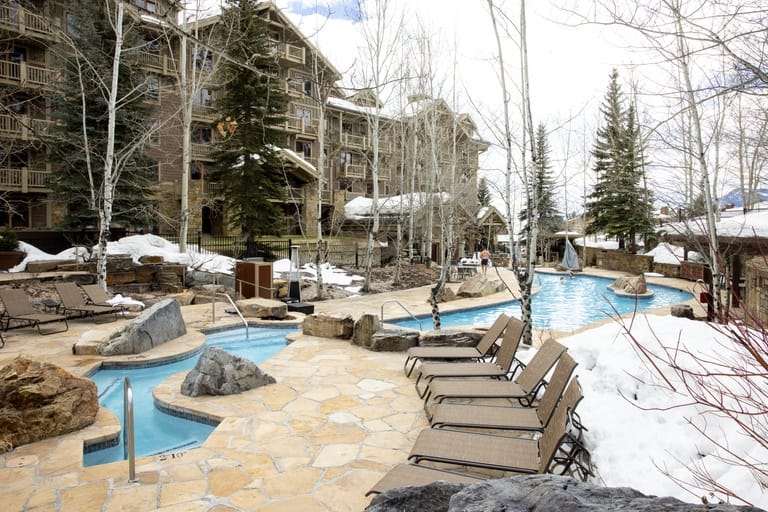 Snowy resort with outdoor pool.