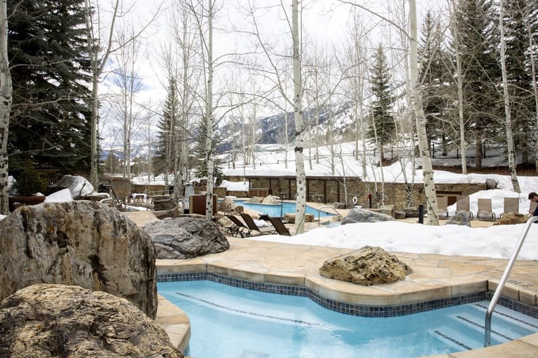 Outdoor pool and snowy landscape.
