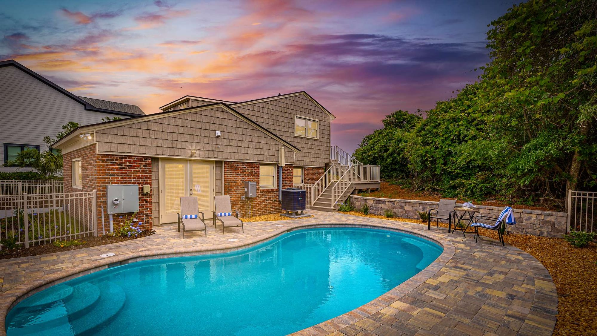 Poolside patio with sunset view.