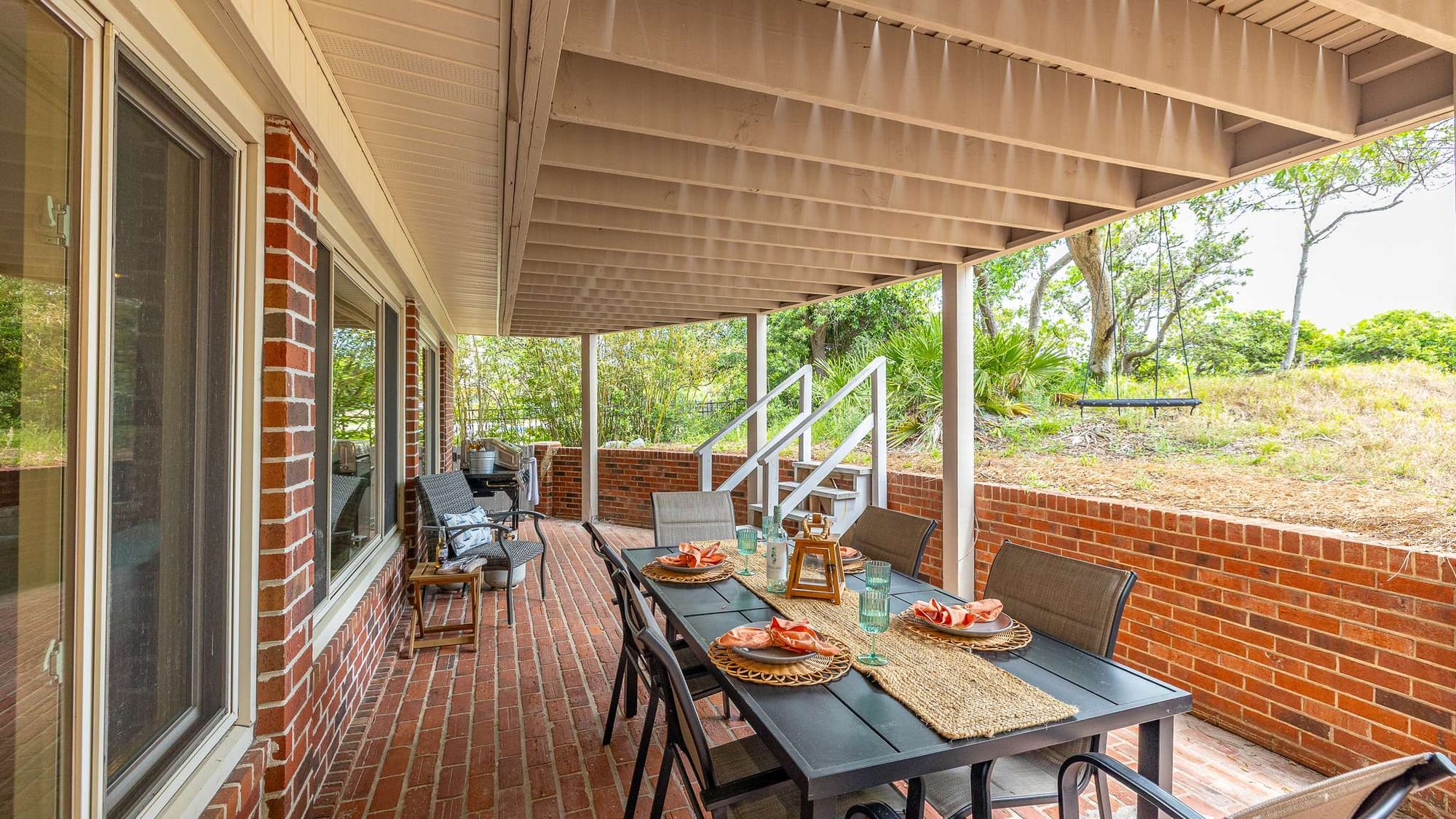 Brick patio with outdoor dining set.