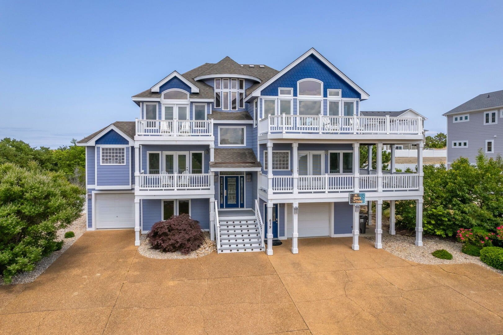 Blue beach house with balconies.