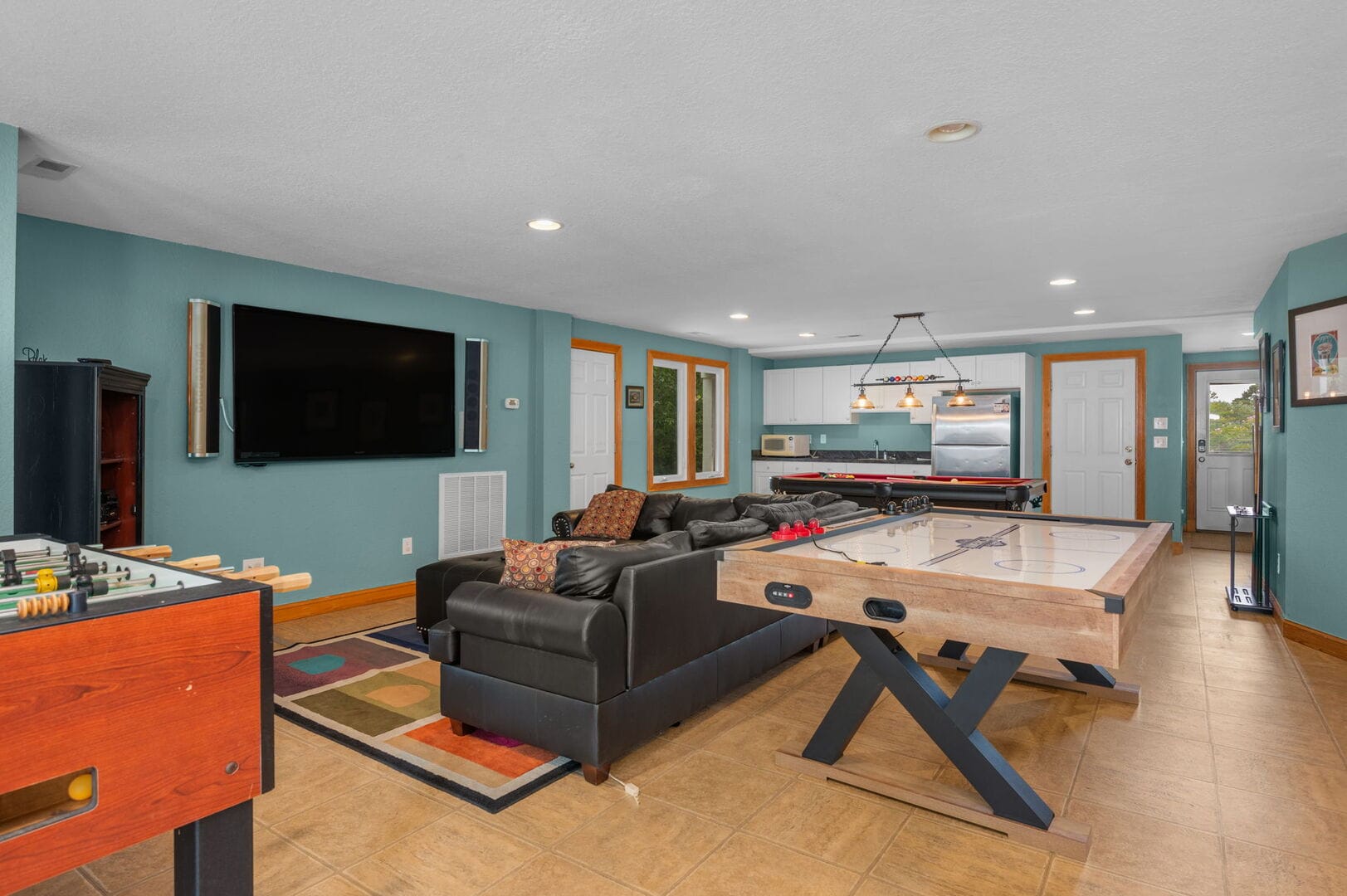 Game room with lounge and kitchen.