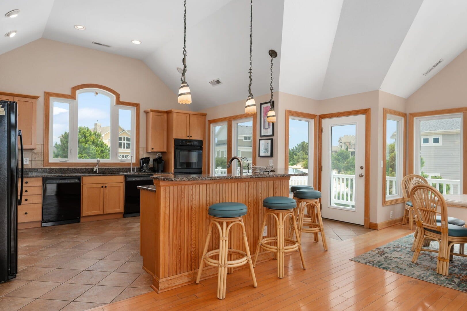 Spacious kitchen with bar stools.