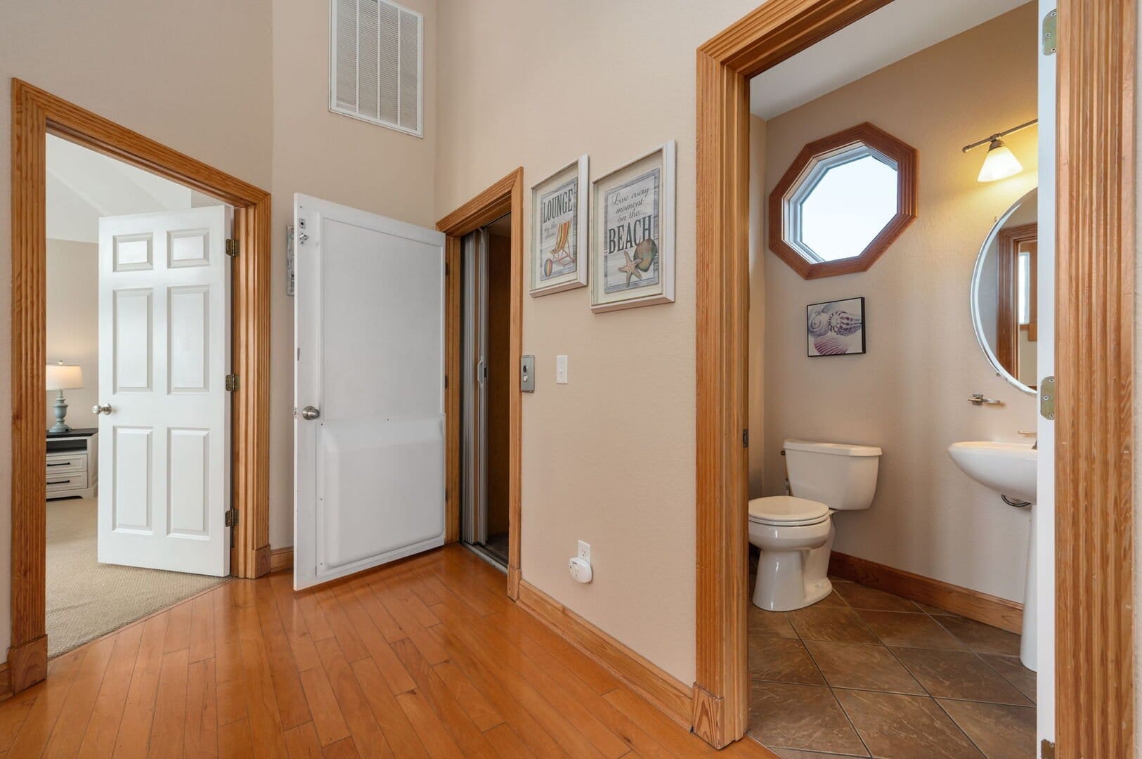 Hallway with bathroom and bedroom.