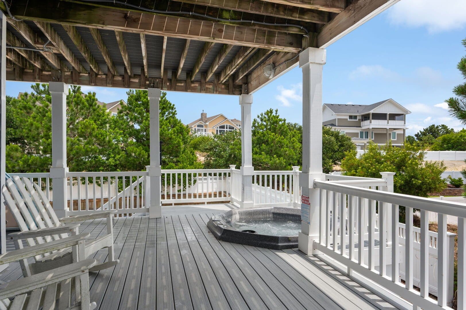 Covered porch with hot tub.