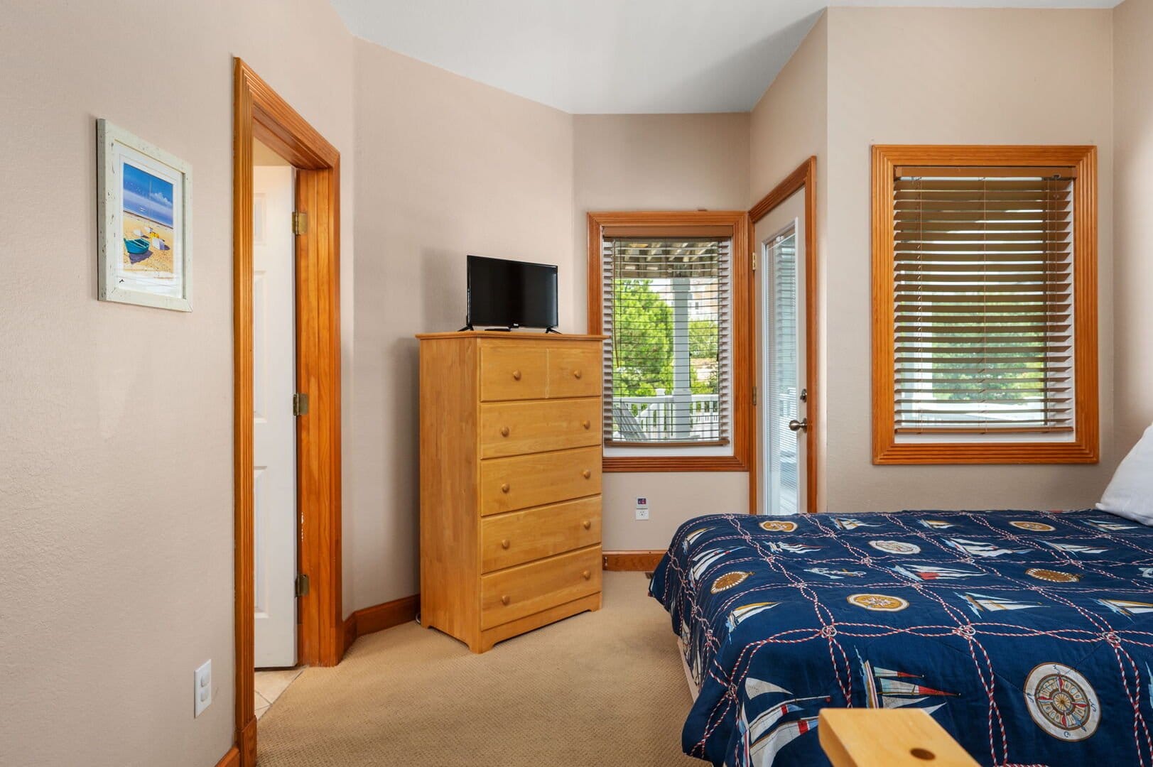 Bedroom with dresser and window.