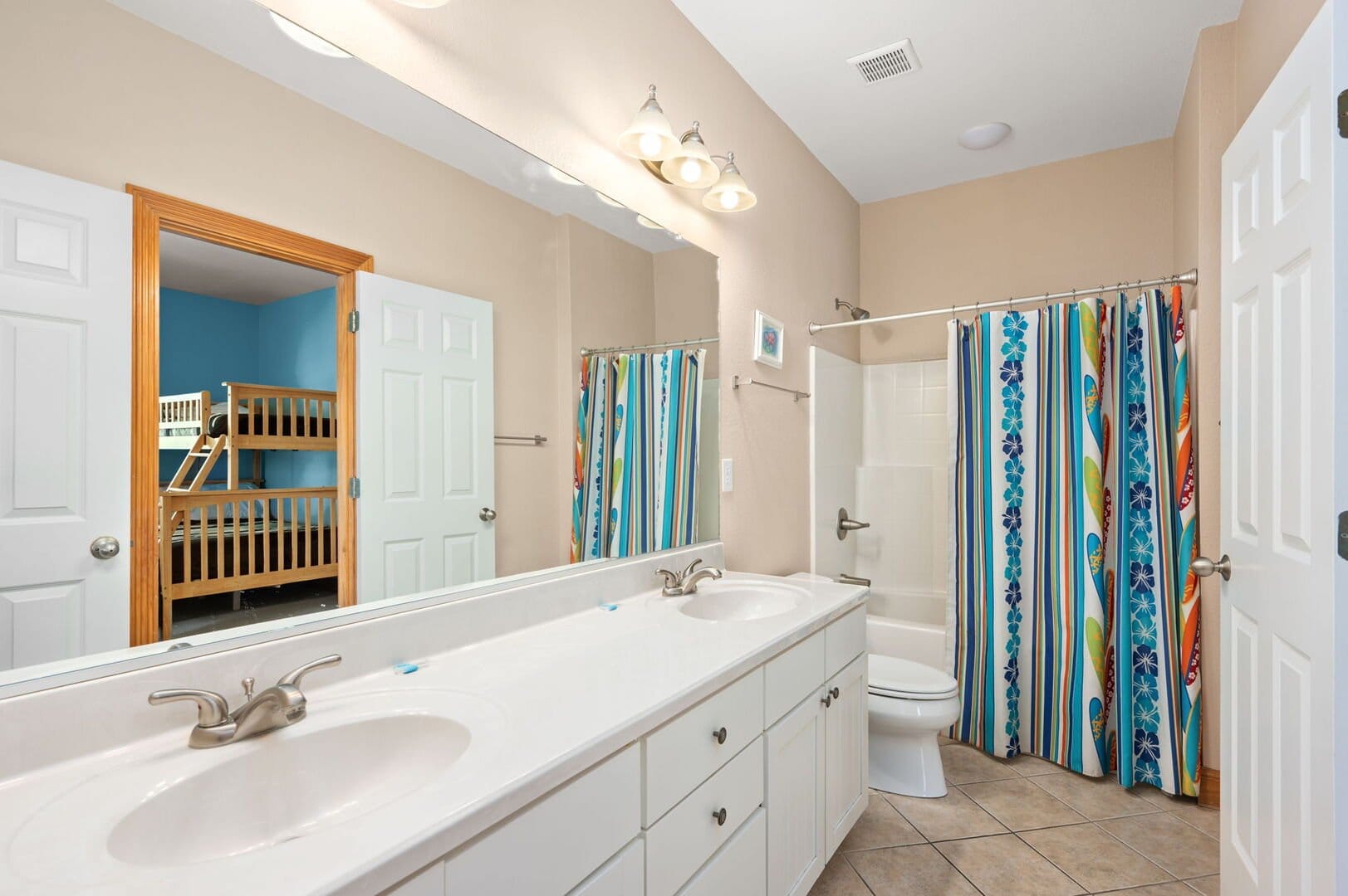 Bathroom with bunk bed reflection.