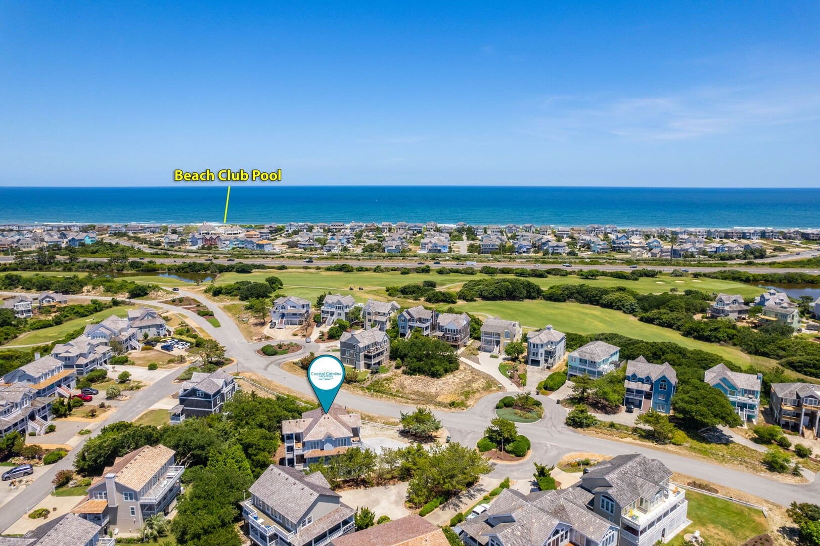 Coastal homes near beach, labeled pool.