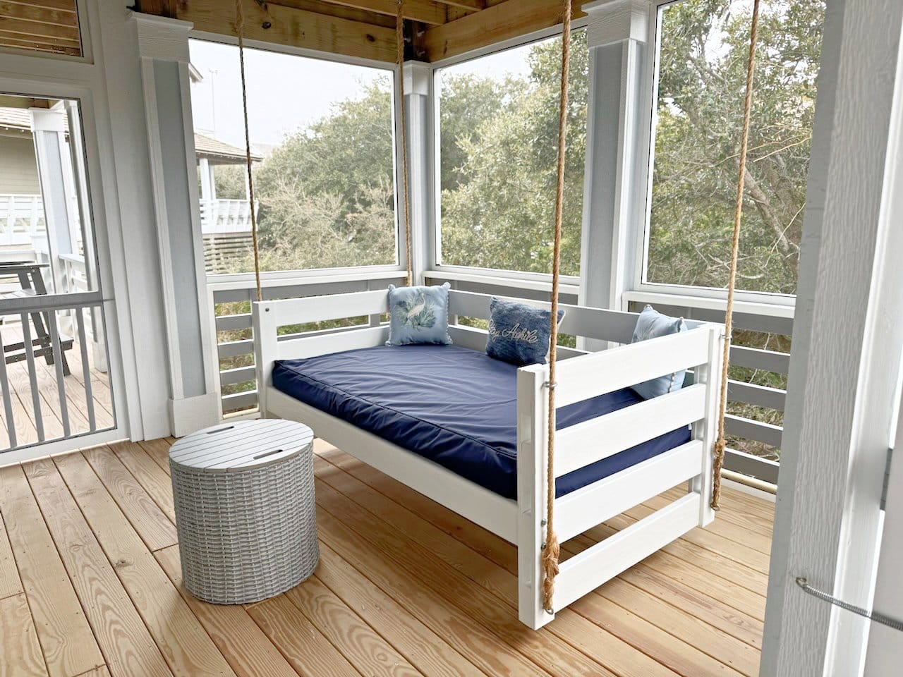 Porch swing bed near table.