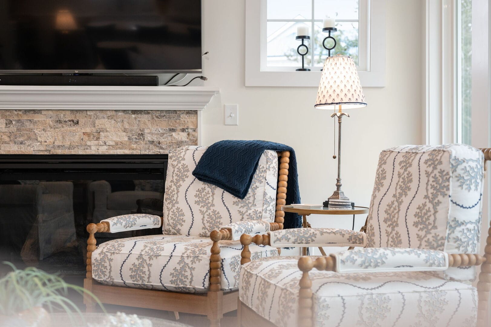 Two armchairs by a fireplace.