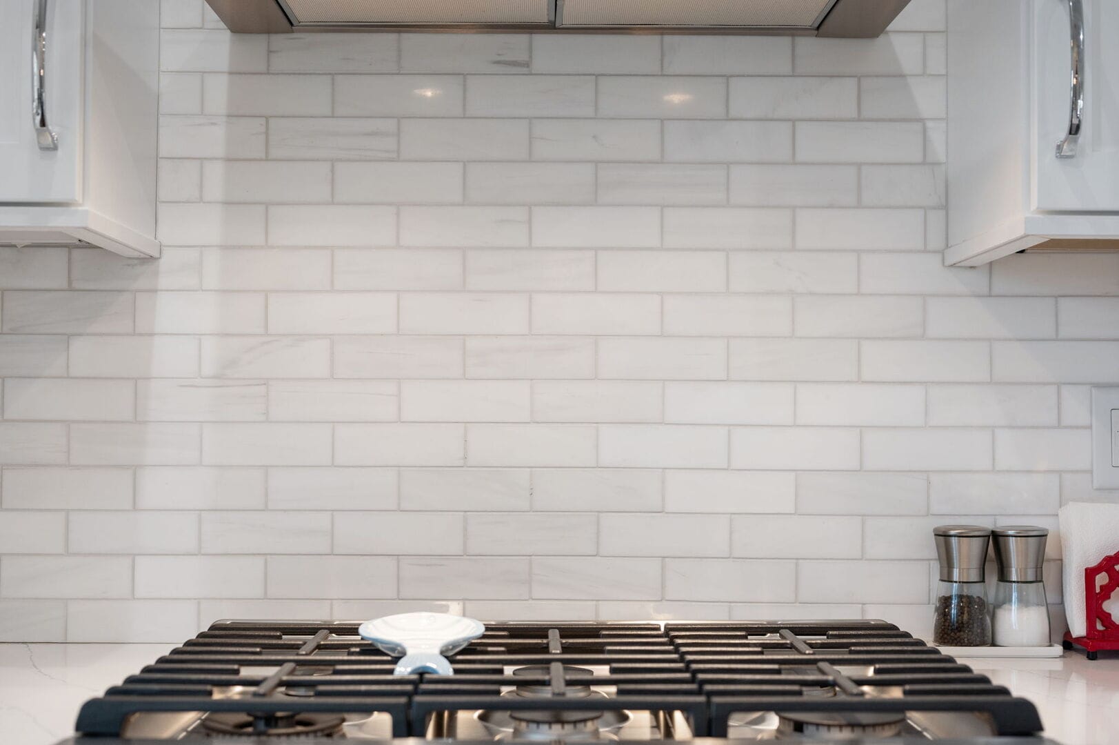 Kitchen stove with tiled backsplash.