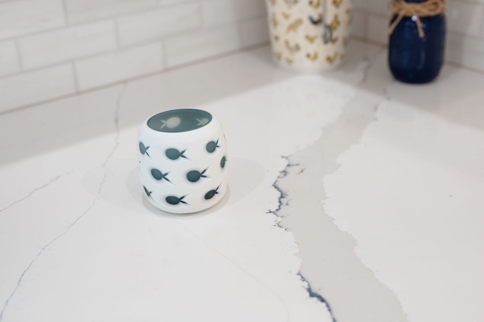 White cup with fish pattern.