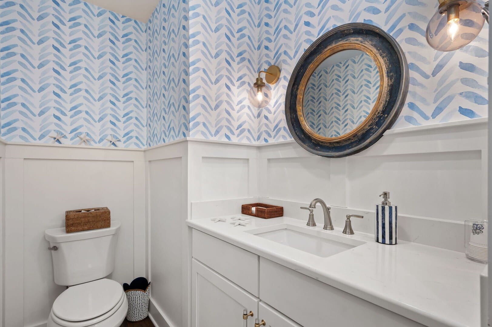 Bathroom with blue patterned wallpaper.