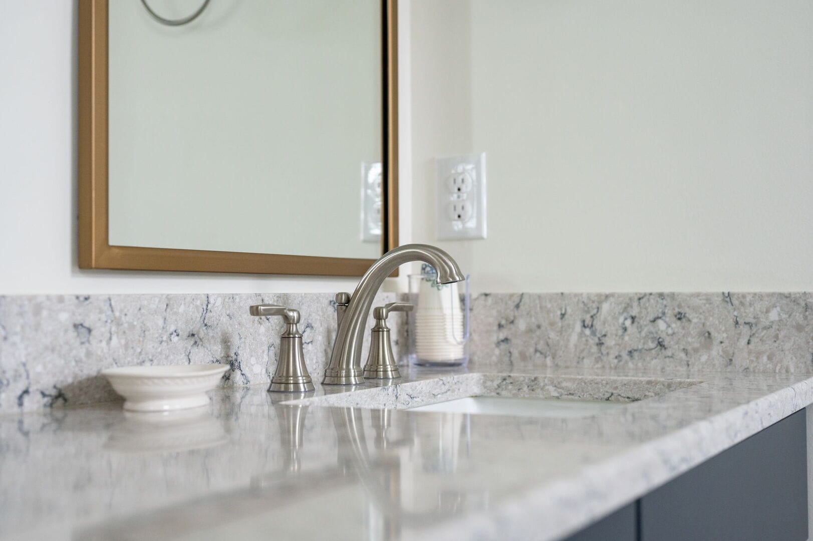 Bathroom countertop with sink and mirror.