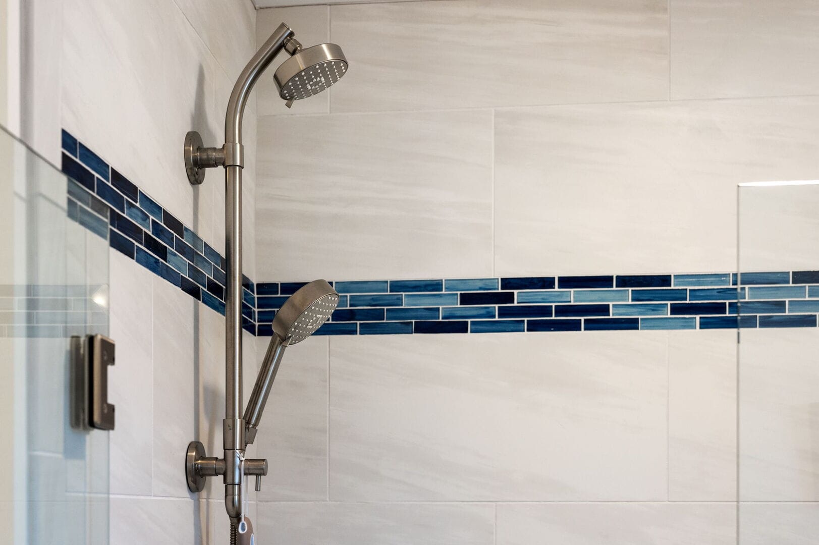 Shower with blue accent tiles.