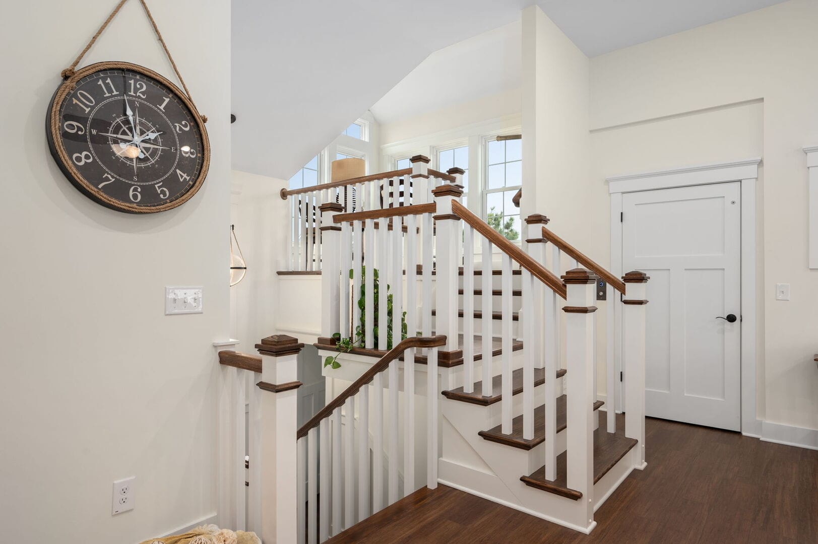 Staircase with large wall clock.