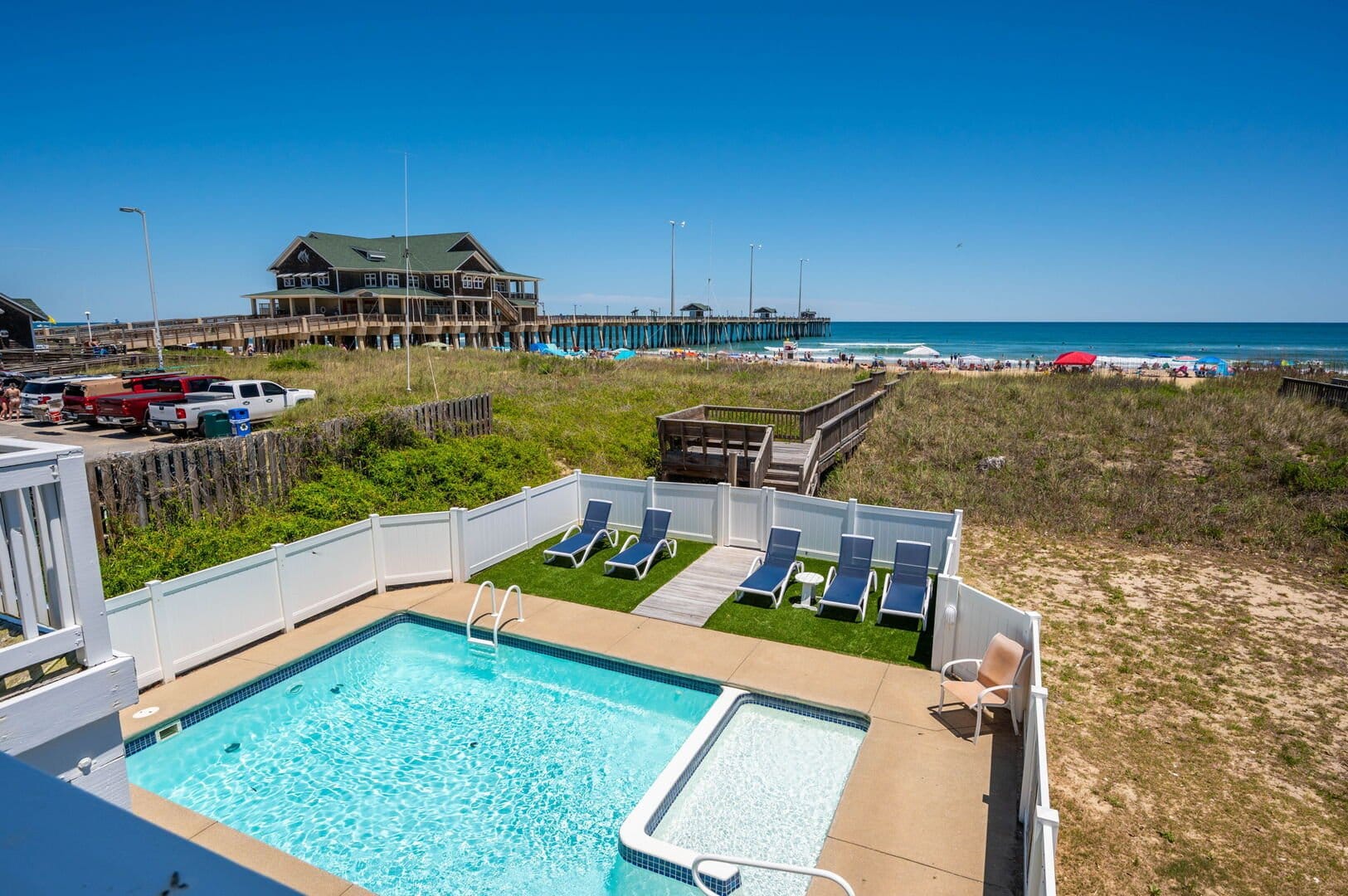 Beachfront pool, boardwalk, and pier.