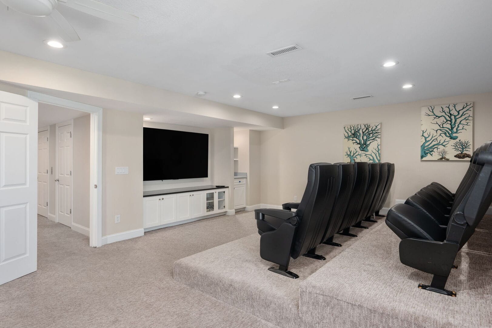 Home theater with black seats.